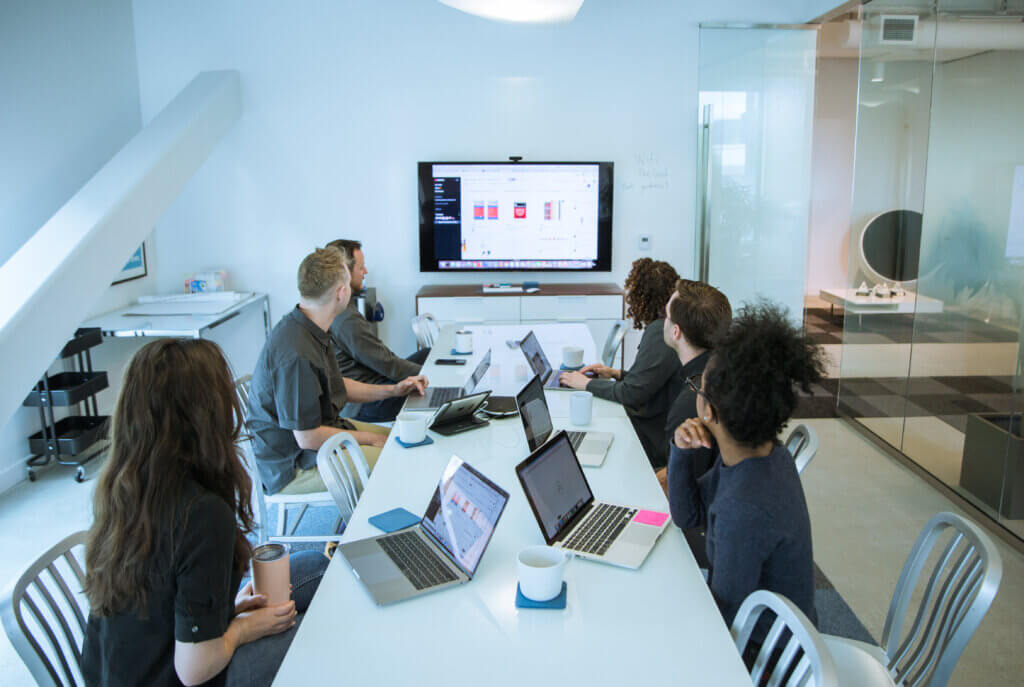 A group of colleagues benefiting from research democratization by sharing customer insights.