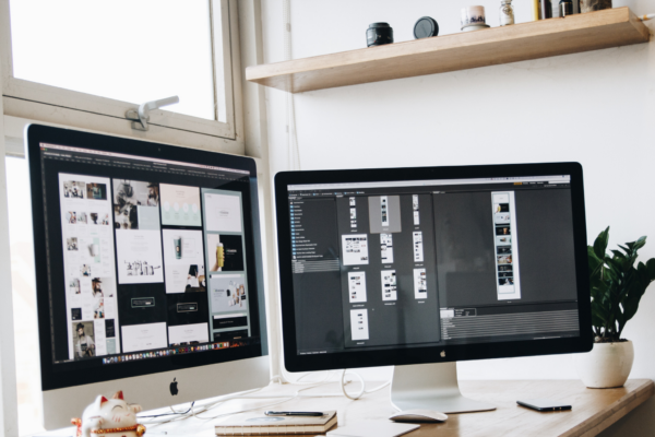 two computer screens showing visual design in progress