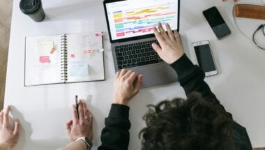 two people viewing a SaaS collaboration feature on a laptop.