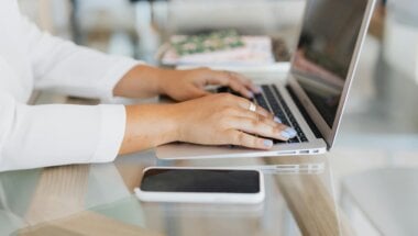 A consumer using a laptop and reviewing pricing models designed with different conversion tactics in mind.