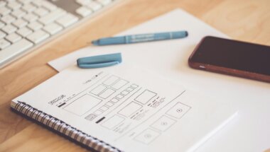 a notebook containing sketches of web design changes.