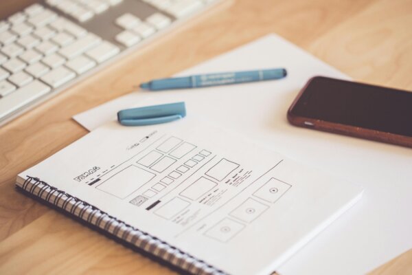 a notebook containing sketches of web design changes.