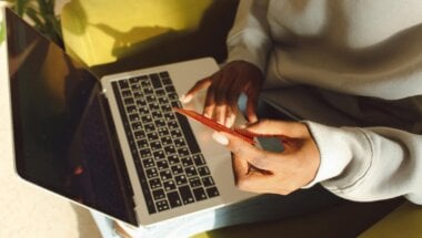 a consumer using laptop to purchase saas upgrades.