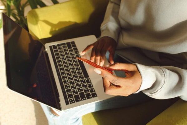 a consumer using laptop to purchase saas upgrades.