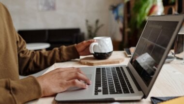 A person using their laptop to view a SaaS free trial pricing page.