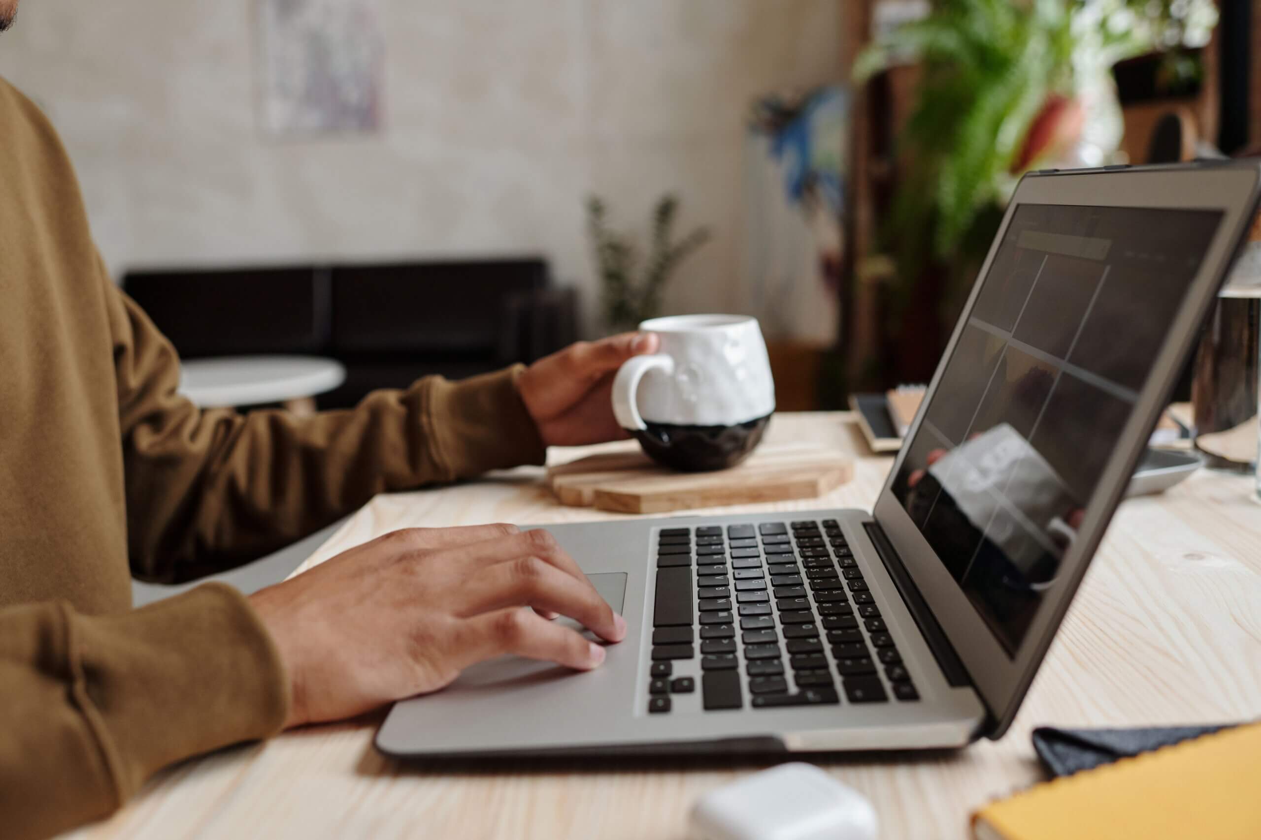A person using their laptop to view a SaaS free trial pricing page.
